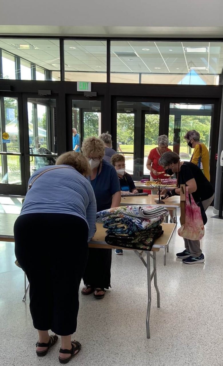 Picking up quilts after the show is over - volunteers helping folks pick up their quilts