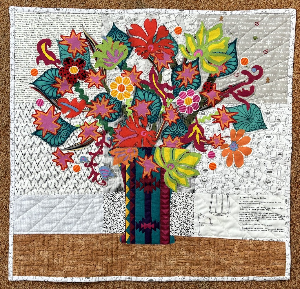 Quilt of Vase full of vibrant colored flowers, lots of warm colors