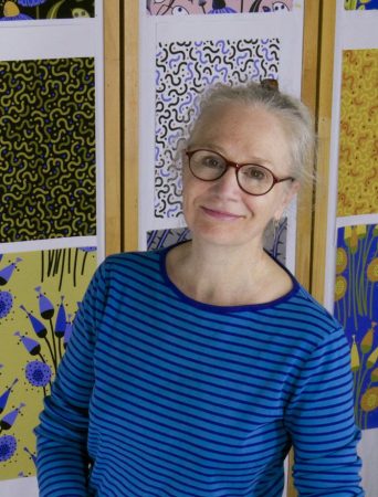 image of Jane Sassaman wearing a blue shirt and black glasses